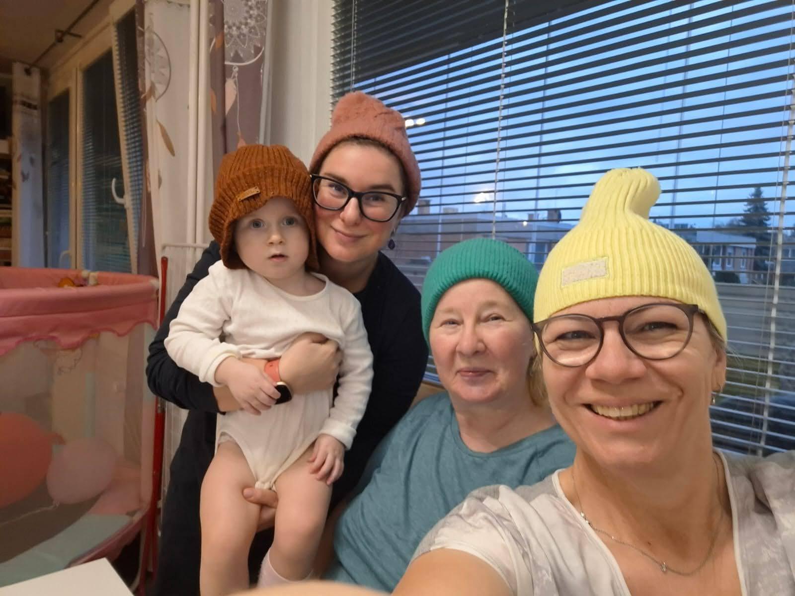 Patrik's wife, daughter, and both grandmothers wearing colorful hats