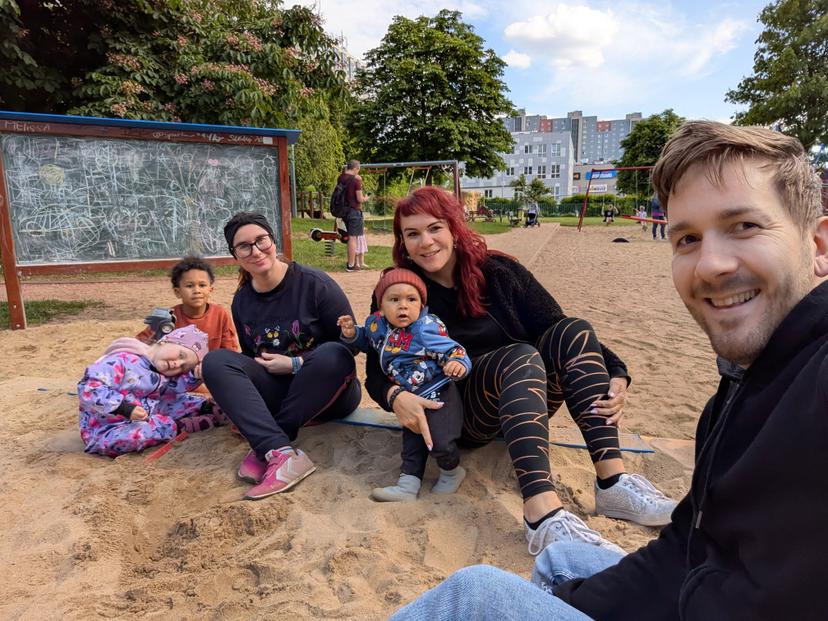 Families at playground with cousins playing together